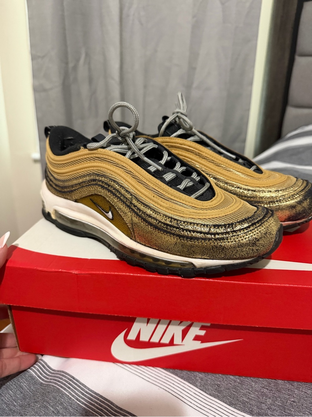 Nike woman’s Air Max 97 in Metallic Gold and Black